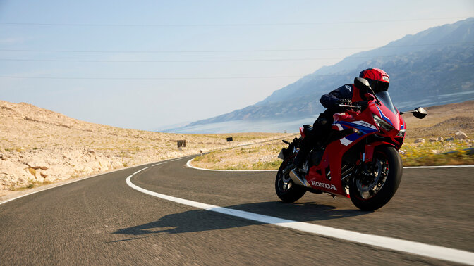 Vista dinámica frontal de tres cuartos de la CBR650R con piloto